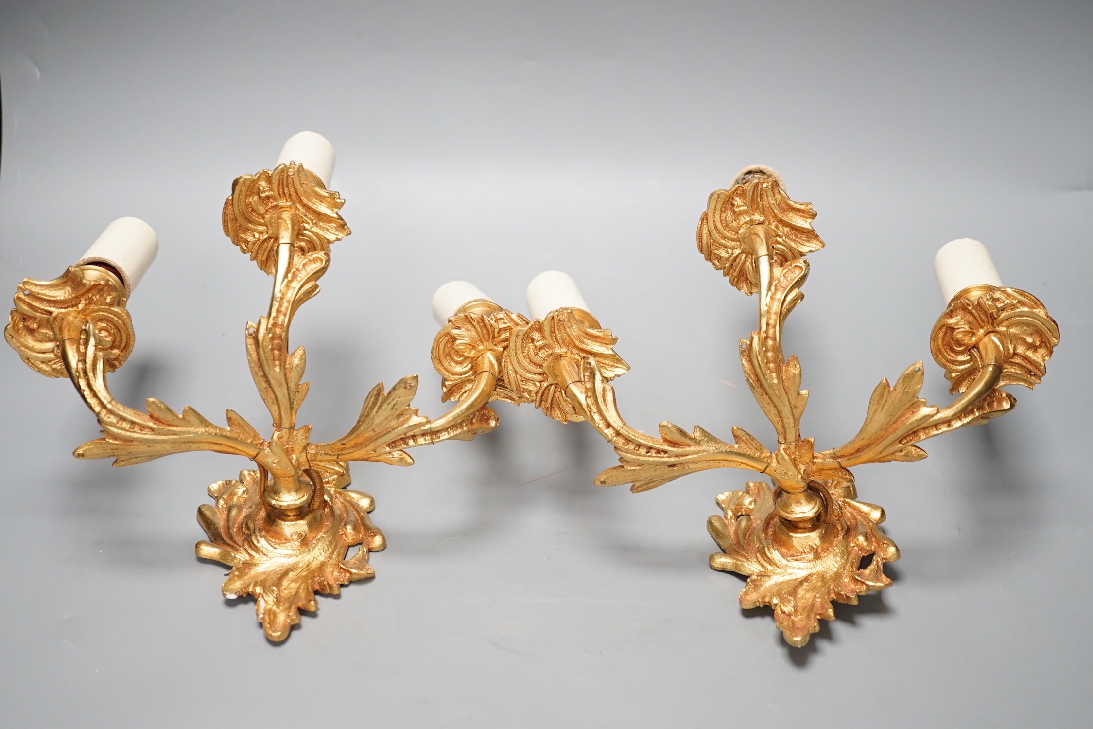 A pair of ormolu three branch wall lights